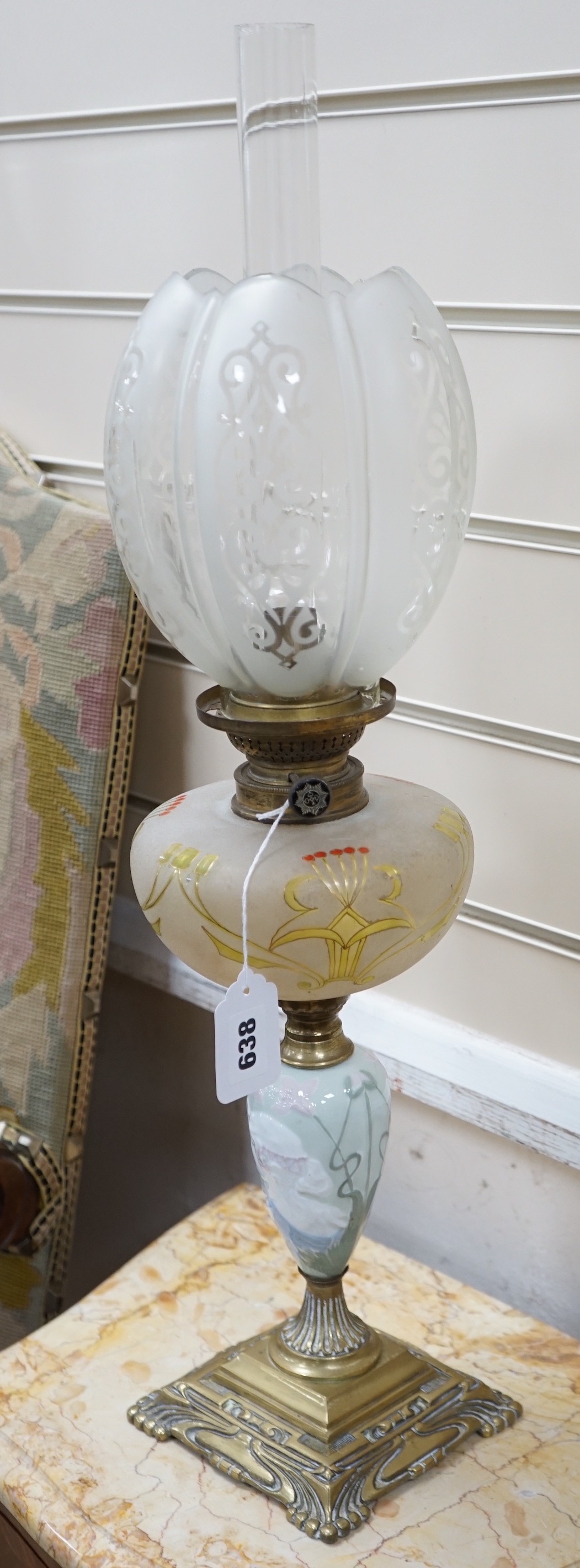 A pair of Art Nouveau decorative porcelain, brass and glass oil lamps. 64cm tall